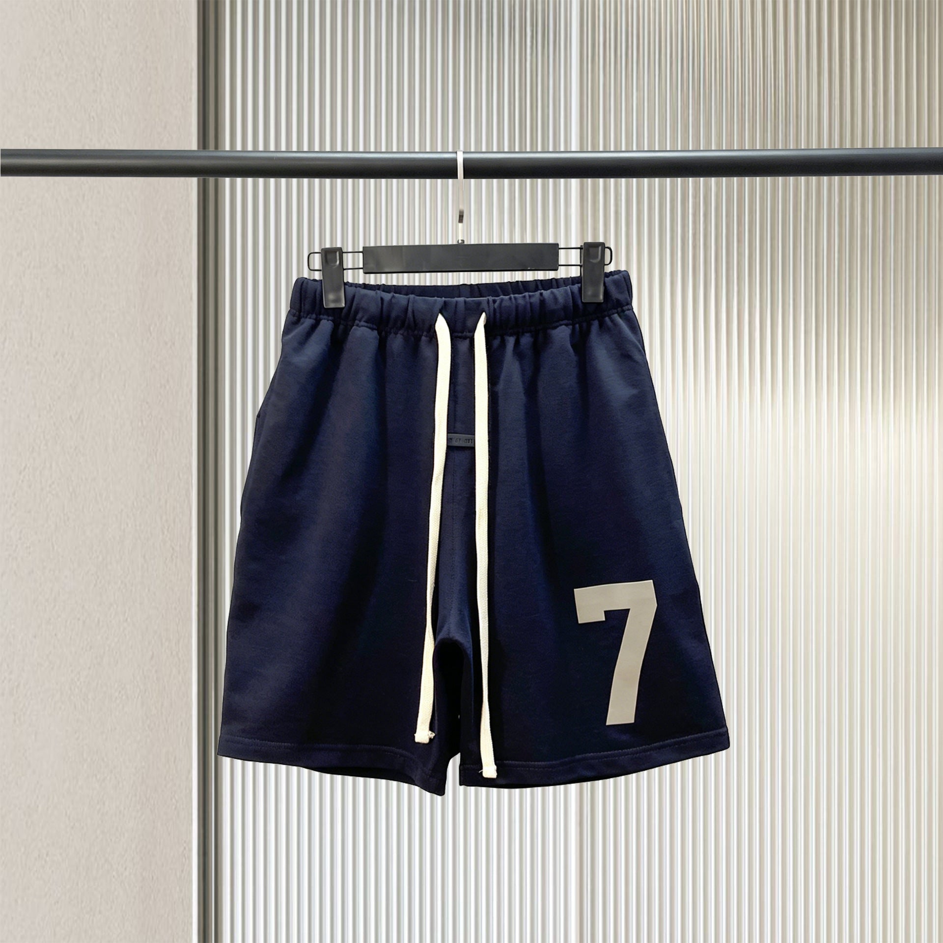 Trendy brand ESSENTIALS men's solid color looped five quarter shorts with drawstring and elastic waist, versatile street shorts